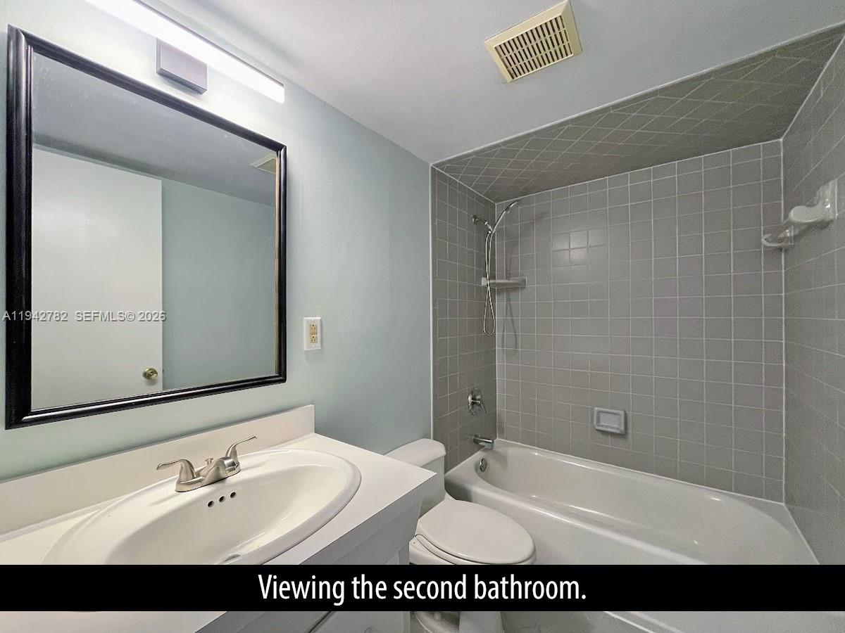 892 Southwest 9th St Circle, Unit 4 Boca Raton, FL 33486 - Photo 17 of 28 a bathroom with a sink shower and a mirror