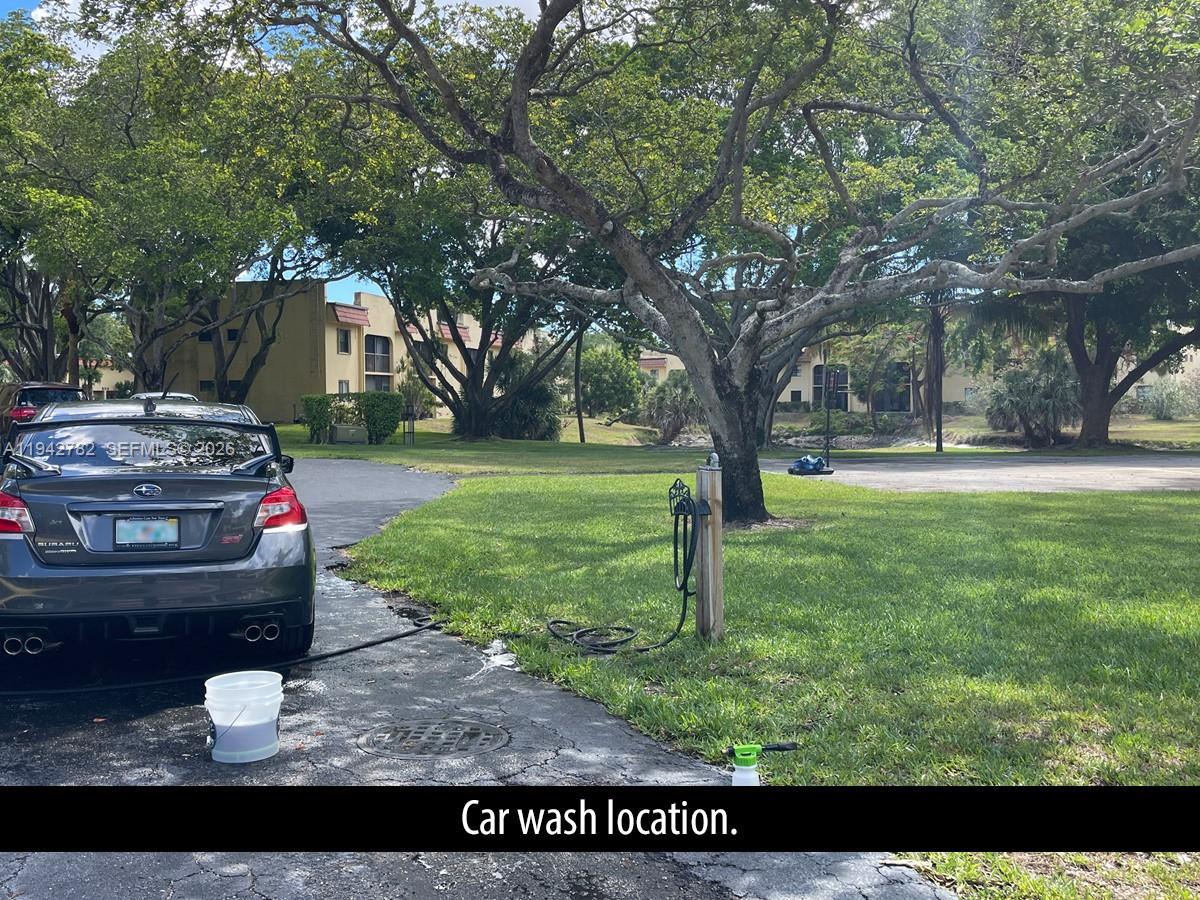 892 Southwest 9th St Circle, Unit 4 Boca Raton, FL 33486 - Photo 27 of 28 a view of a backyard with trees