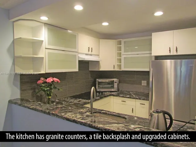 a kitchen with a sink a stove and cabinets