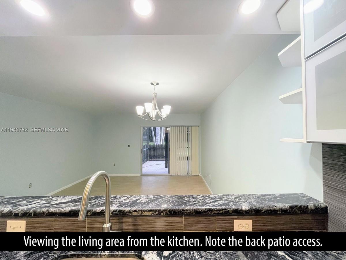 892 Southwest 9th St Circle, Unit 4 Boca Raton, FL 33486 - Photo 8 of 28 a view of a kitchen with granite countertop stove top oven and cabinets