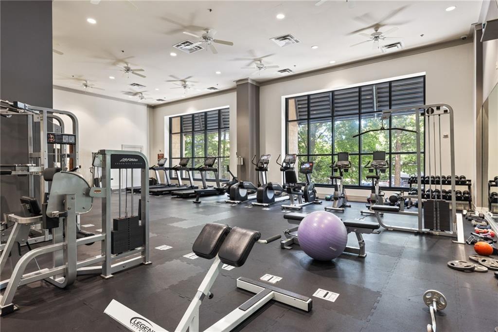 3040 Peachtree Road Northwest, Unit 605 Atlanta, GA 30305 - Photo 11 of 29 a room with gym equipment and a large window