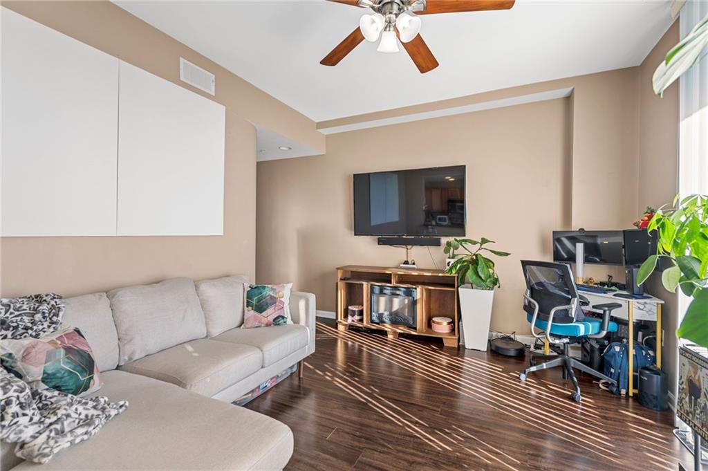 3040 Peachtree Road Northwest, Unit 605 Atlanta, GA 30305 - Photo 14 of 29 a living room with furniture and a flat screen tv