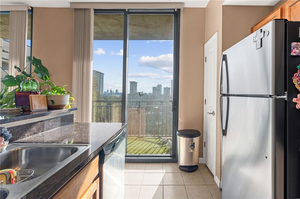 3040 Peachtree Road Northwest, Unit 605 Atlanta, GA 30305 - Photo 18 of 29 a kitchen with a refrigerator and sink