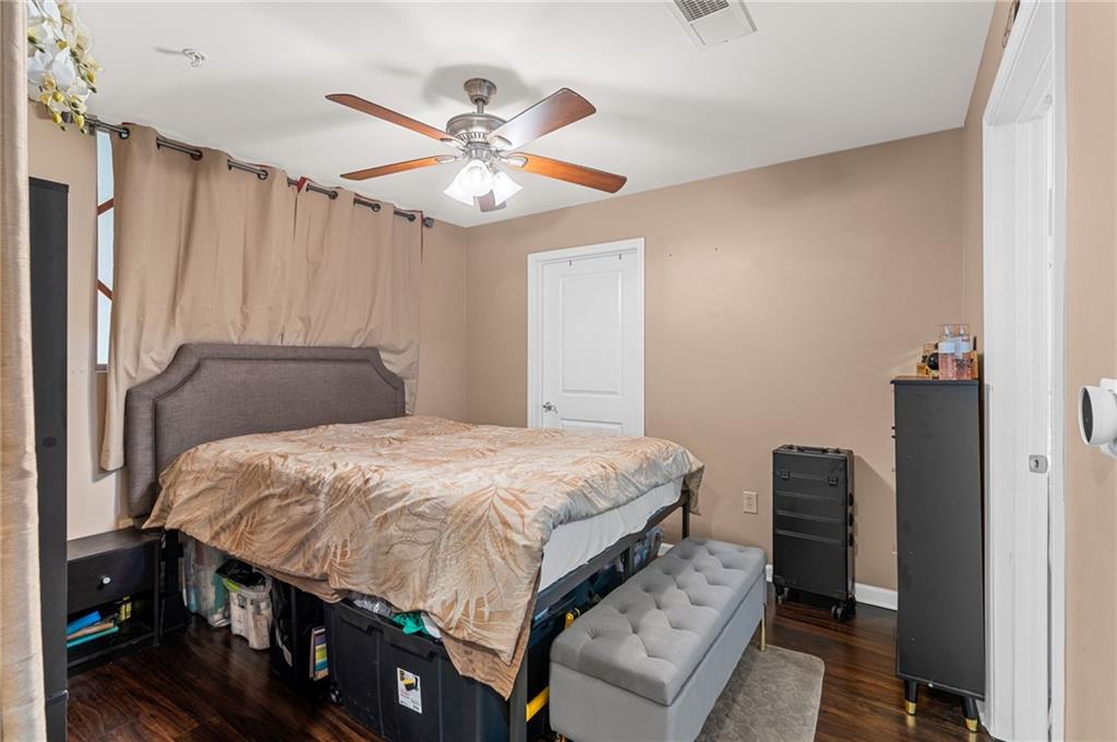 3040 Peachtree Road Northwest, Unit 605 Atlanta, GA 30305 - Photo 20 of 29 a bedroom with a bed and a chandelier