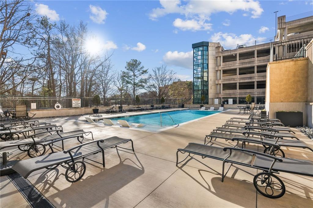 3040 Peachtree Road Northwest, Unit 605 Atlanta, GA 30305 - Photo 27 of 29 a view of a swimming pool with lounge chair