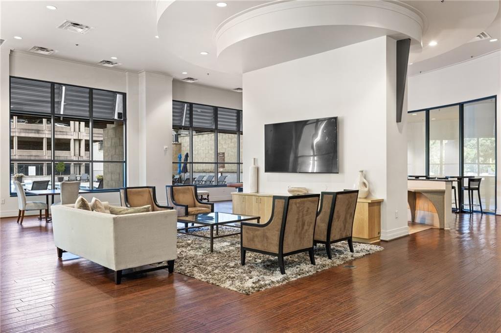 3040 Peachtree Road Northwest, Unit 605 Atlanta, GA 30305 - Photo 4 of 29 a living room with furniture and a flat screen tv