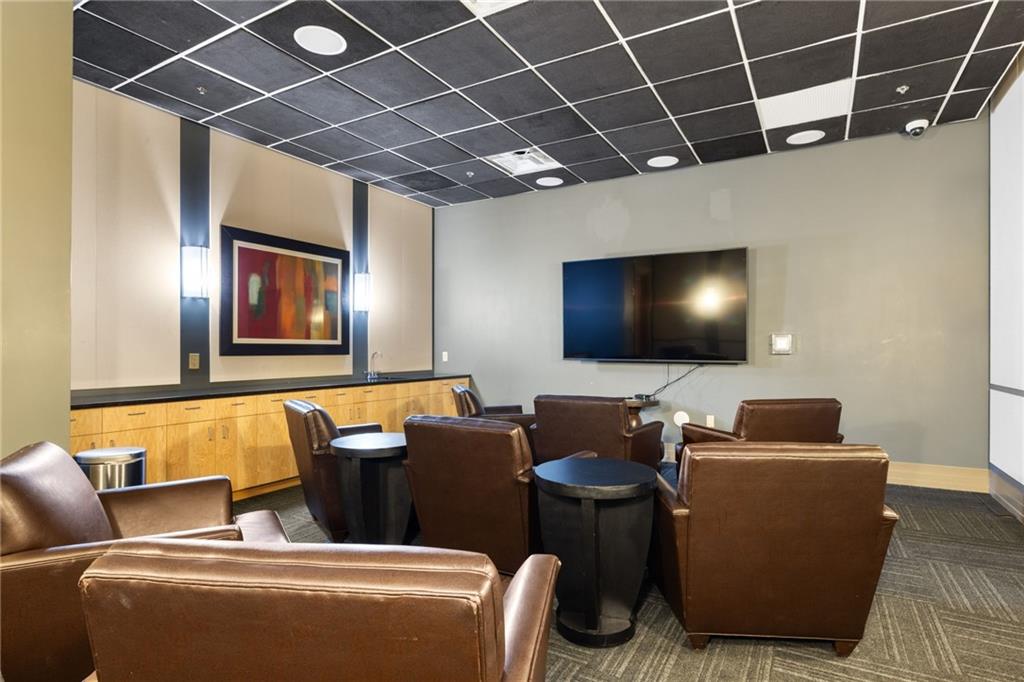 3040 Peachtree Road Northwest, Unit 605 Atlanta, GA 30305 - Photo 8 of 29 a living room with furniture and a flat screen tv