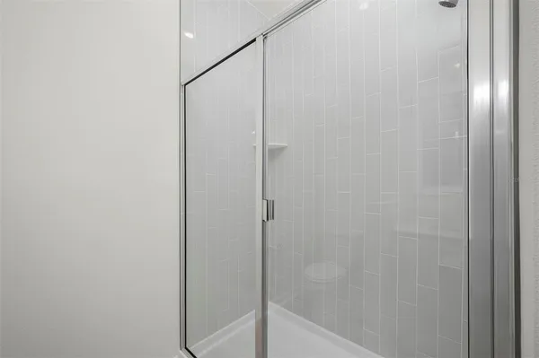a bathroom with a glass shower door
