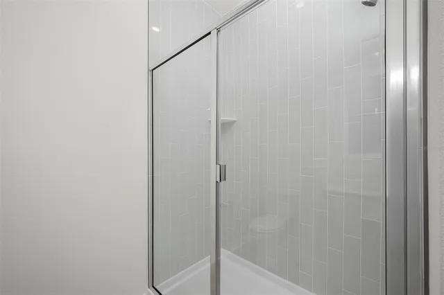 a bathroom with a glass shower door