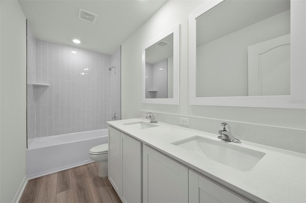 13288 Tula Loop Astatula, FL 34705 - Photo 20 of 23 a bathroom with a sink a toilet and shower