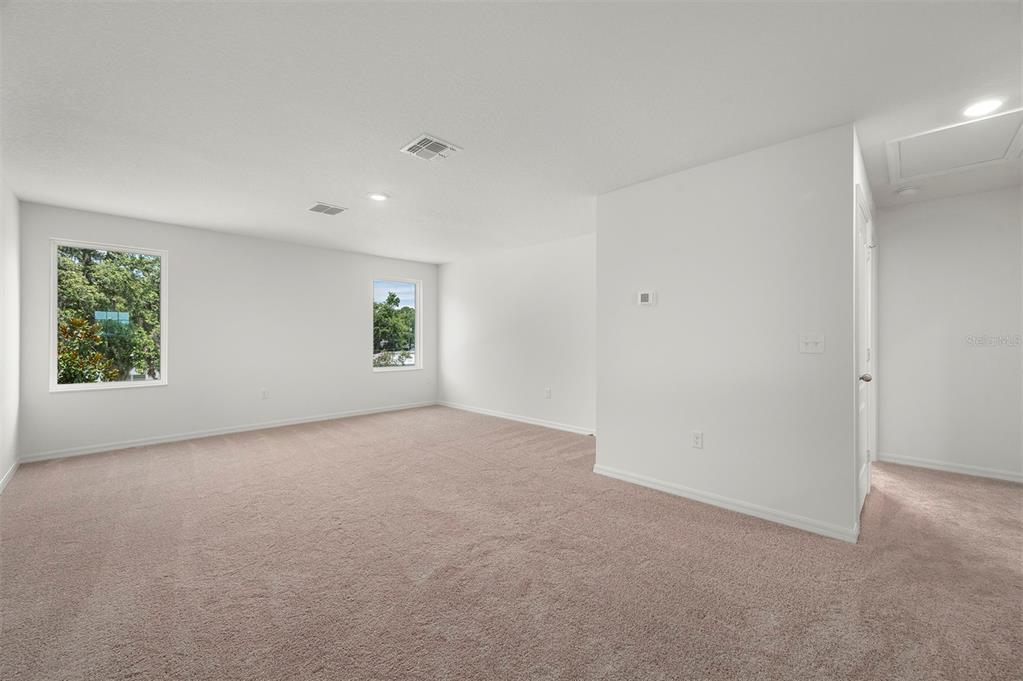 13288 Tula Loop Astatula, FL 34705 - Photo 10 of 23 a view of a big room with windows