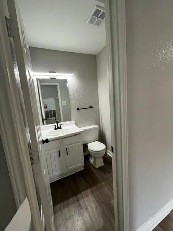 a kitchen with granite countertop a refrigerator stove and microwave