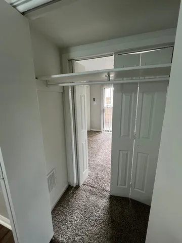 a view of a refrigerator in kitchen and wooden floor