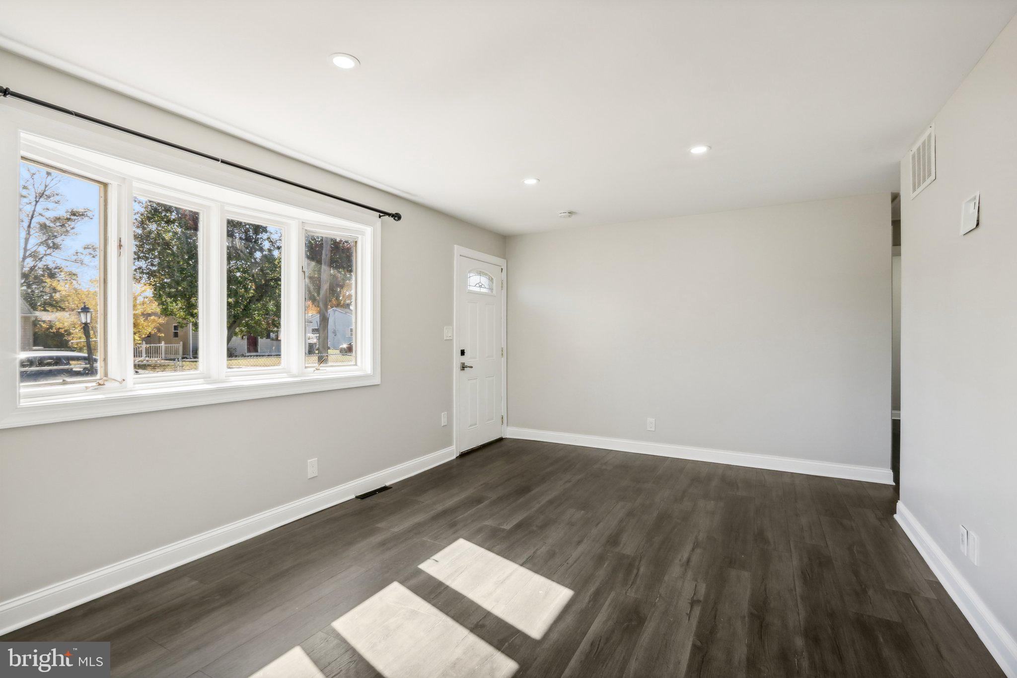 935 Mt Road Burlington, NJ 08016 - Photo 11 of 36 an empty room with wooden floor and windows