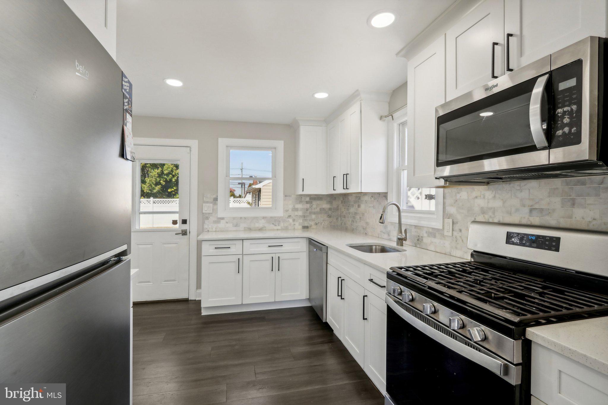 935 Mt Road Burlington, NJ 08016 - Photo 12 of 36 a kitchen with stainless steel appliances white cabinets granite counter tops and a window