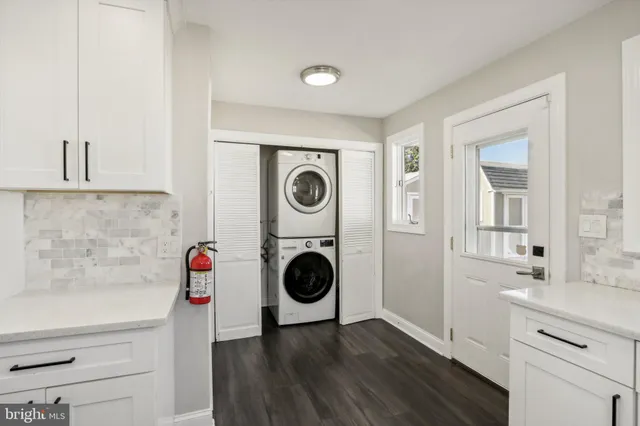 a utility room with sink dryer and washer