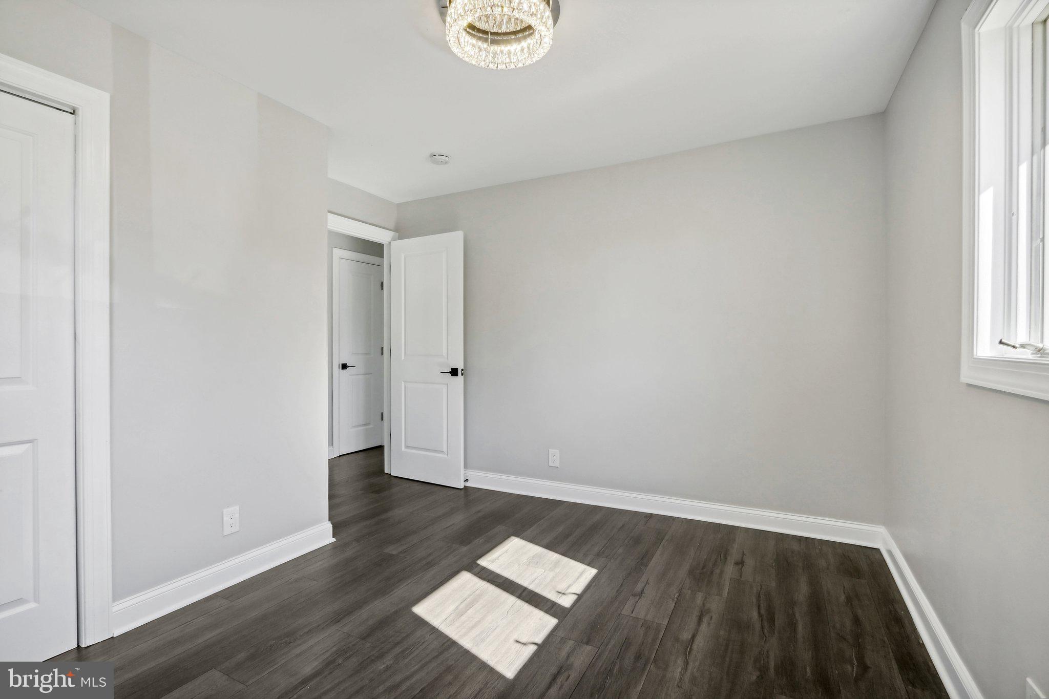 935 Mt Road Burlington, NJ 08016 - Photo 21 of 36 an empty room with wooden floor and windows