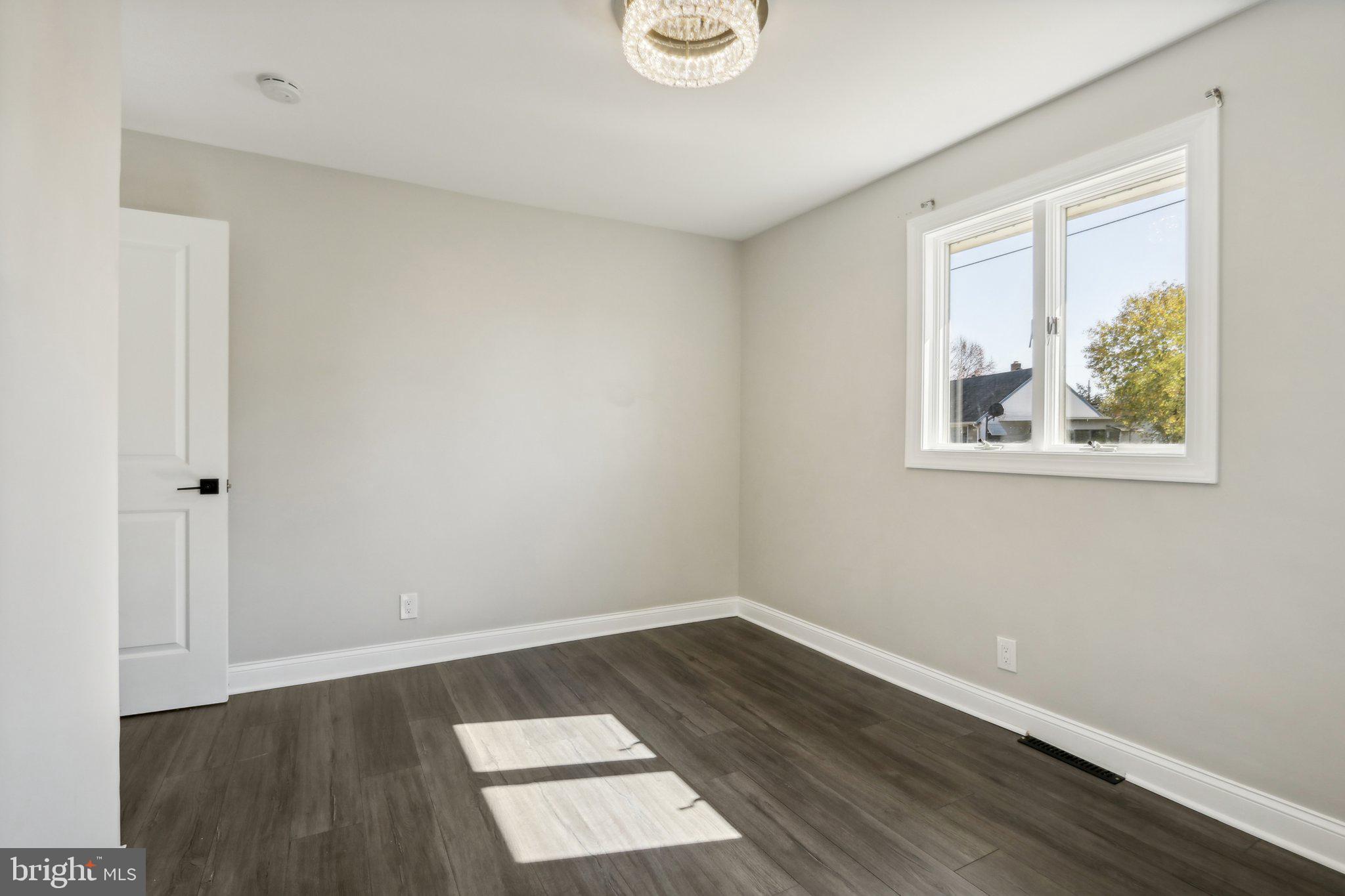 935 Mt Road Burlington, NJ 08016 - Photo 22 of 36 an empty room with wooden floor and window