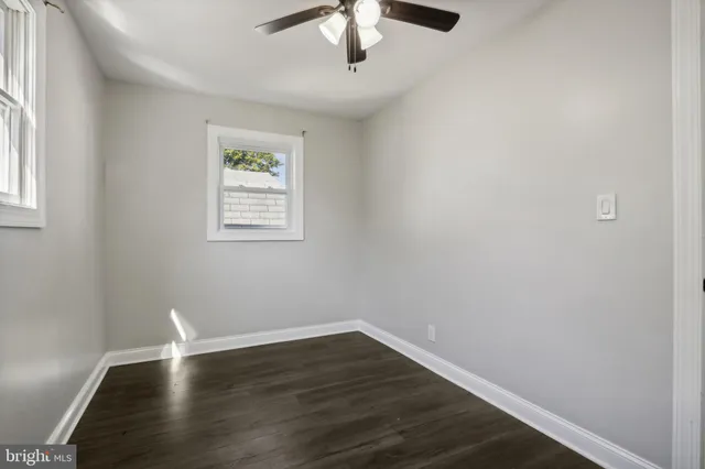 a view of wooden floor chandelier and window in a room