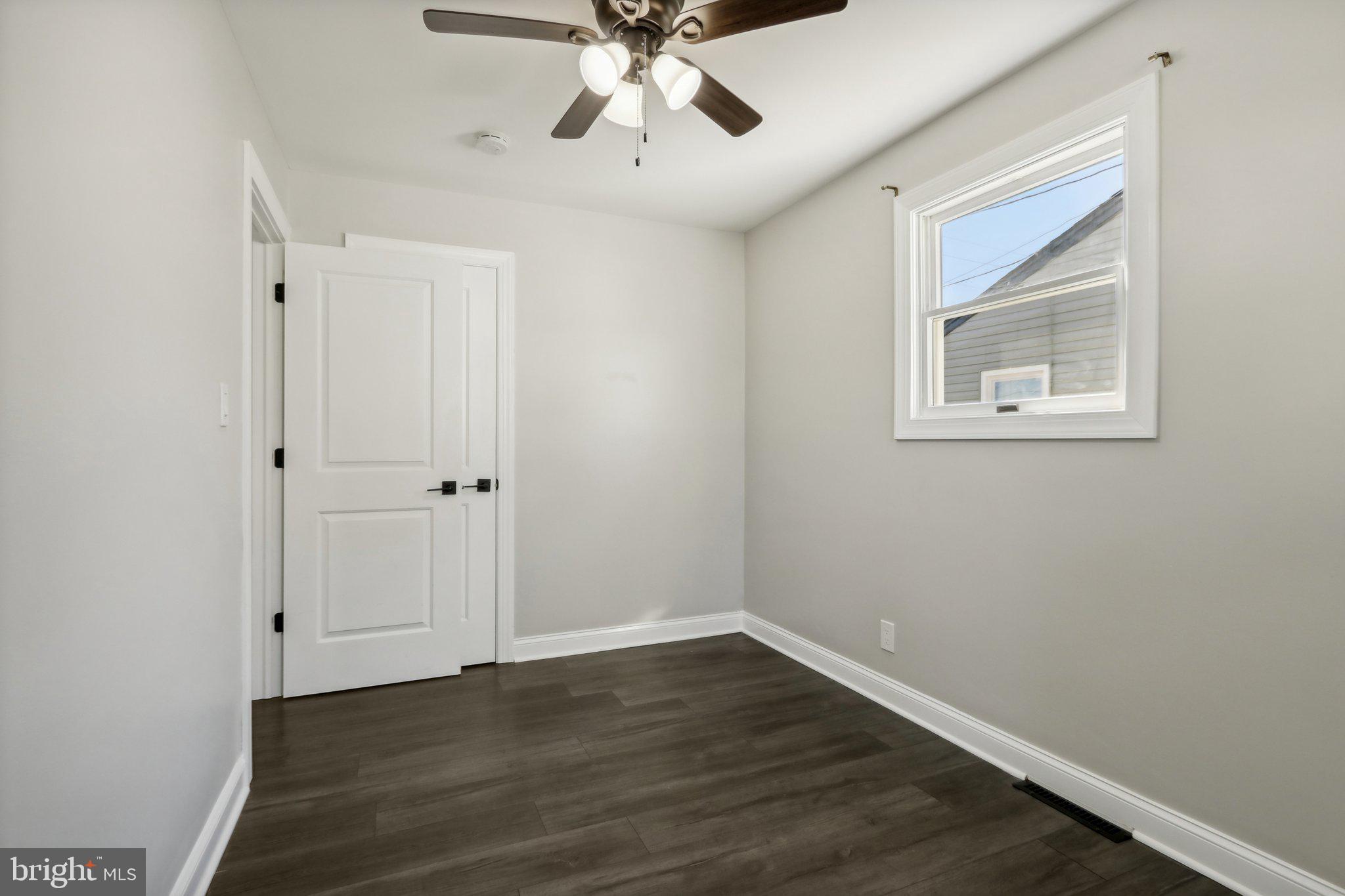935 Mt Road Burlington, NJ 08016 - Photo 26 of 36 a view of an empty room with wooden floor and a ceiling fan