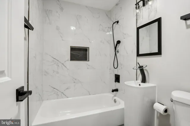 a bathroom with a sink mirror and a bathtub