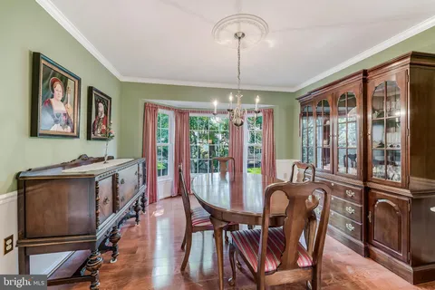 a kitchen with granite countertop wooden cabinets a sink a window and stainless steel appliances