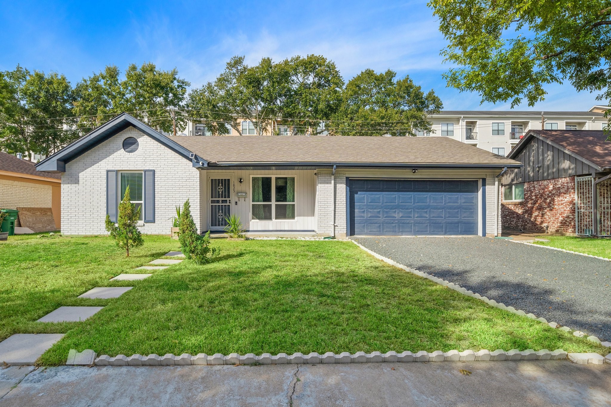 1825 Locksford Street Houston, TX 77008 - Photo 1 of 30 a front view of a house with a garden