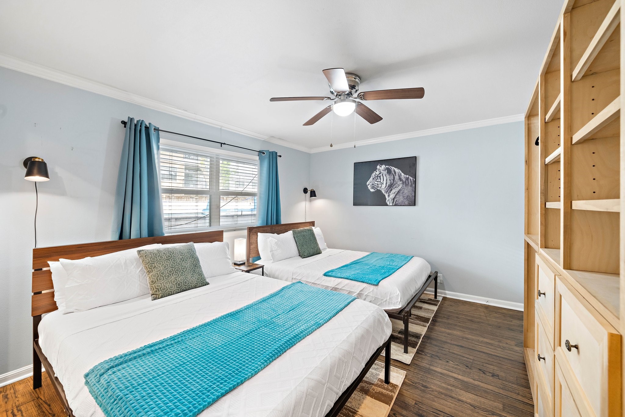 1825 Locksford Street Houston, TX 77008 - Photo 20 of 30 a bedroom with a bed a dresser and wooden floor