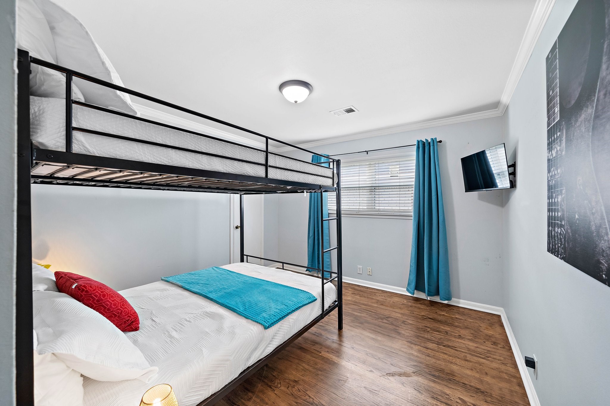 1825 Locksford Street Houston, TX 77008 - Photo 24 of 30 a bedroom with a bed and a wooden floor