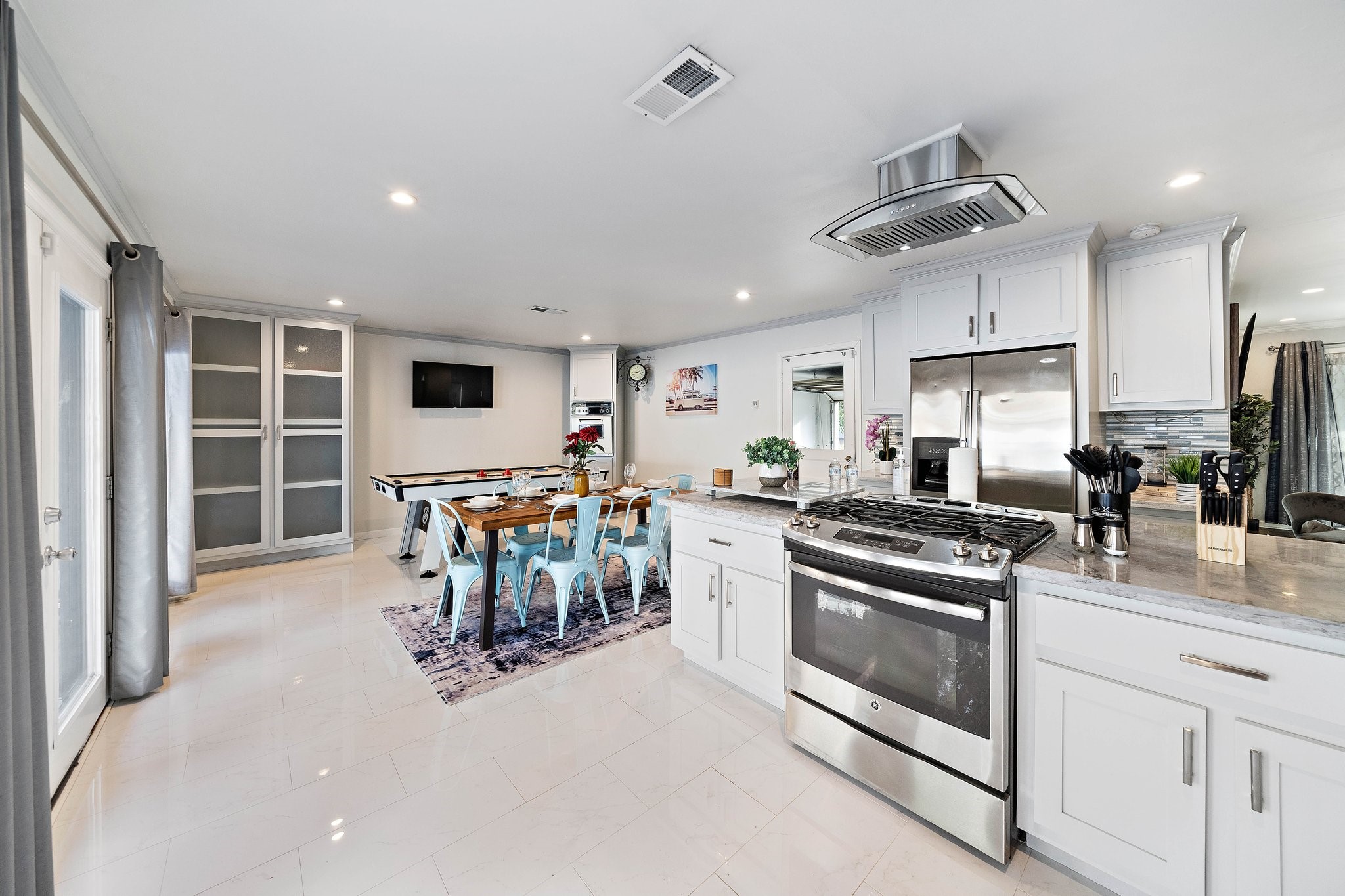 1825 Locksford Street Houston, TX 77008 - Photo 5 of 30 a kitchen with stainless steel appliances kitchen island granite countertop a stove and a sink