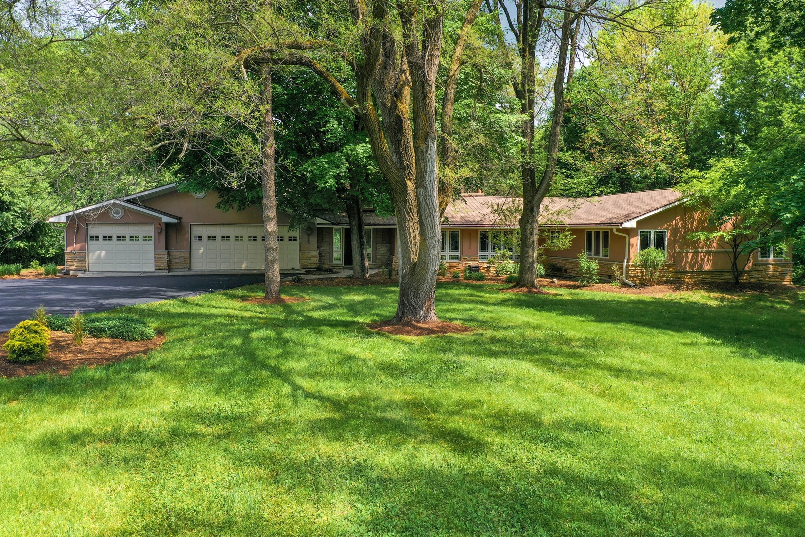 7704 Newbold Road Cary, IL 60013 - Photo 1 of 56 a front view of a house with garden