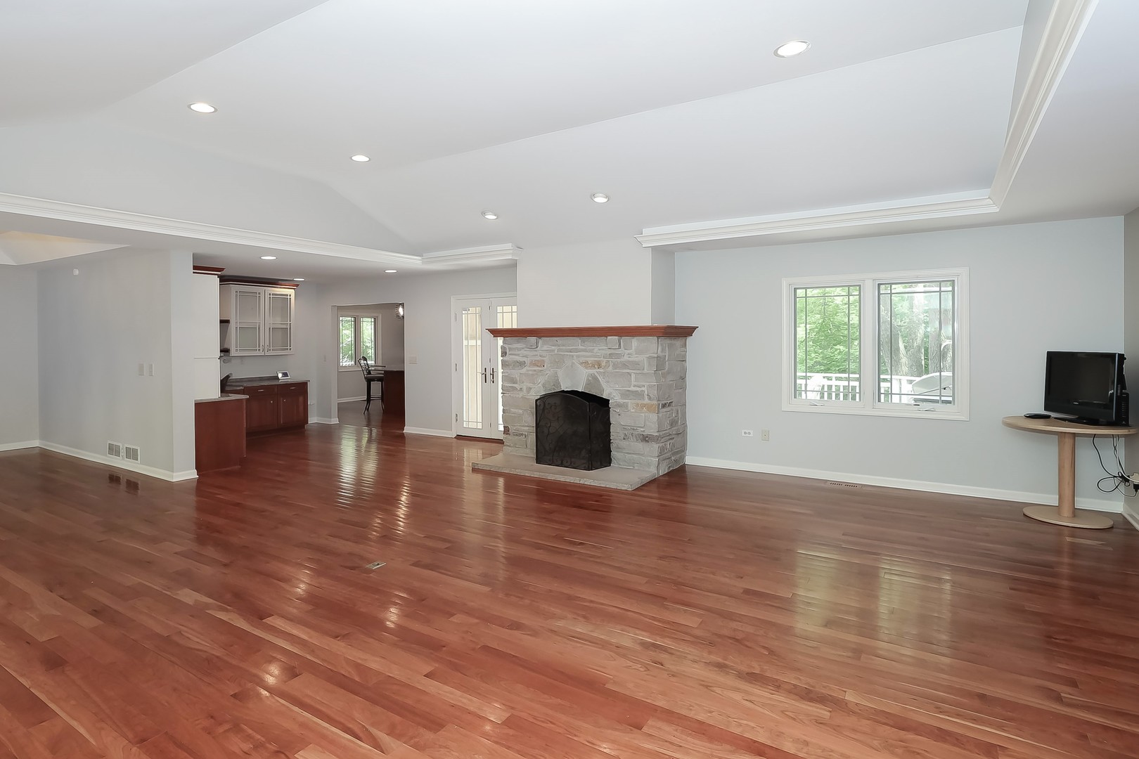 7704 Newbold Road Cary, IL 60013 - Photo 11 of 56 an empty room with fireplace wooden floor and windows