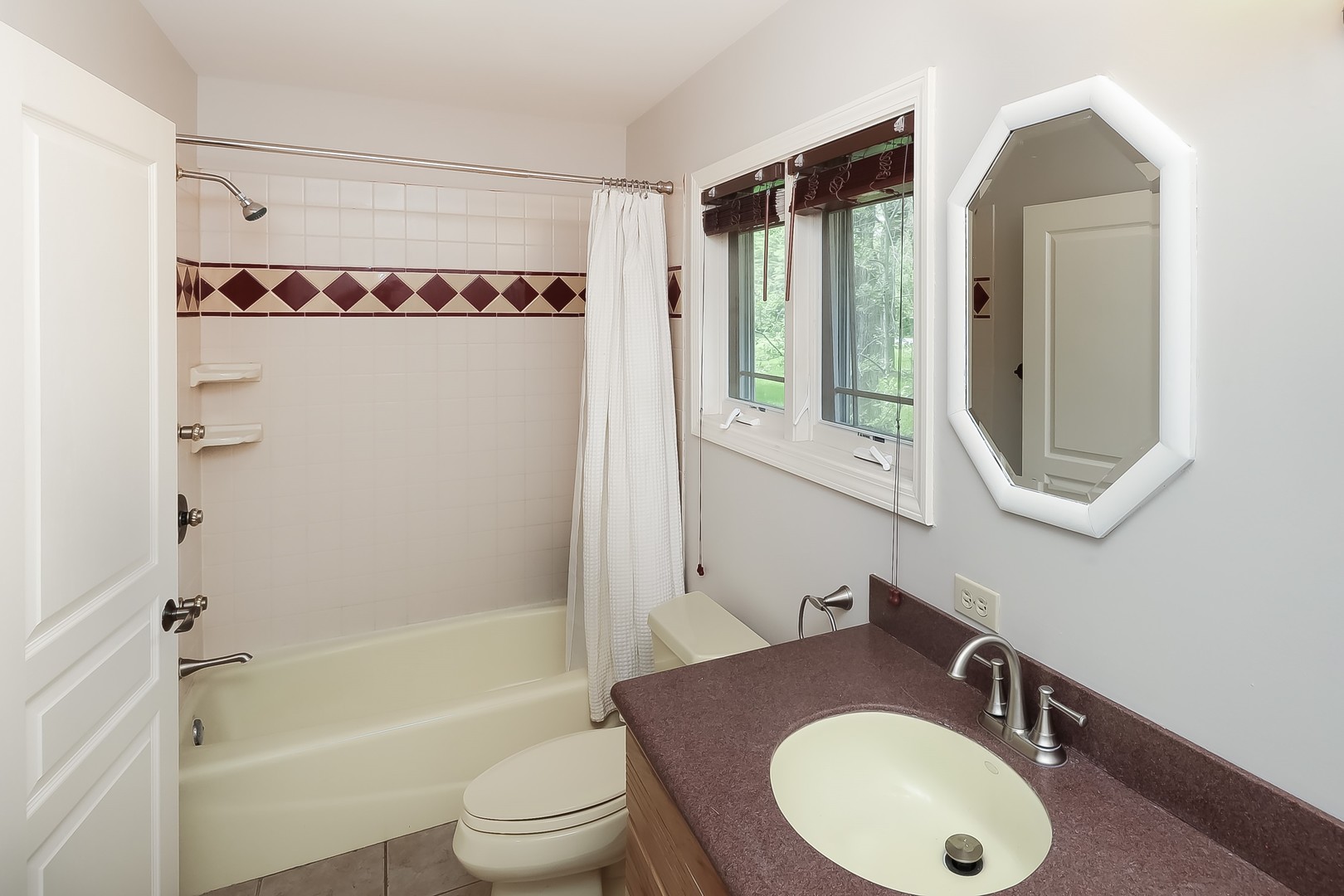 7704 Newbold Road Cary, IL 60013 - Photo 32 of 56 a bathroom with a sink a toilet and a mirror