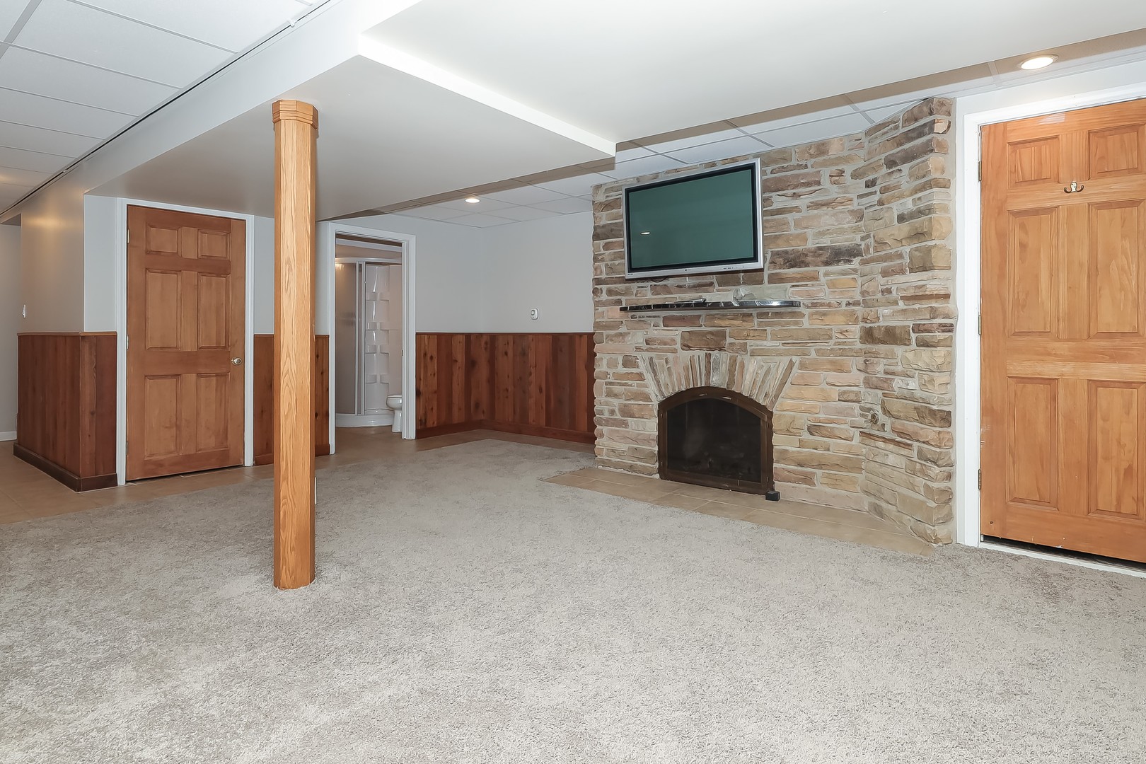 7704 Newbold Road Cary, IL 60013 - Photo 36 of 56 a living room with furniture a fireplace and a flat screen tv