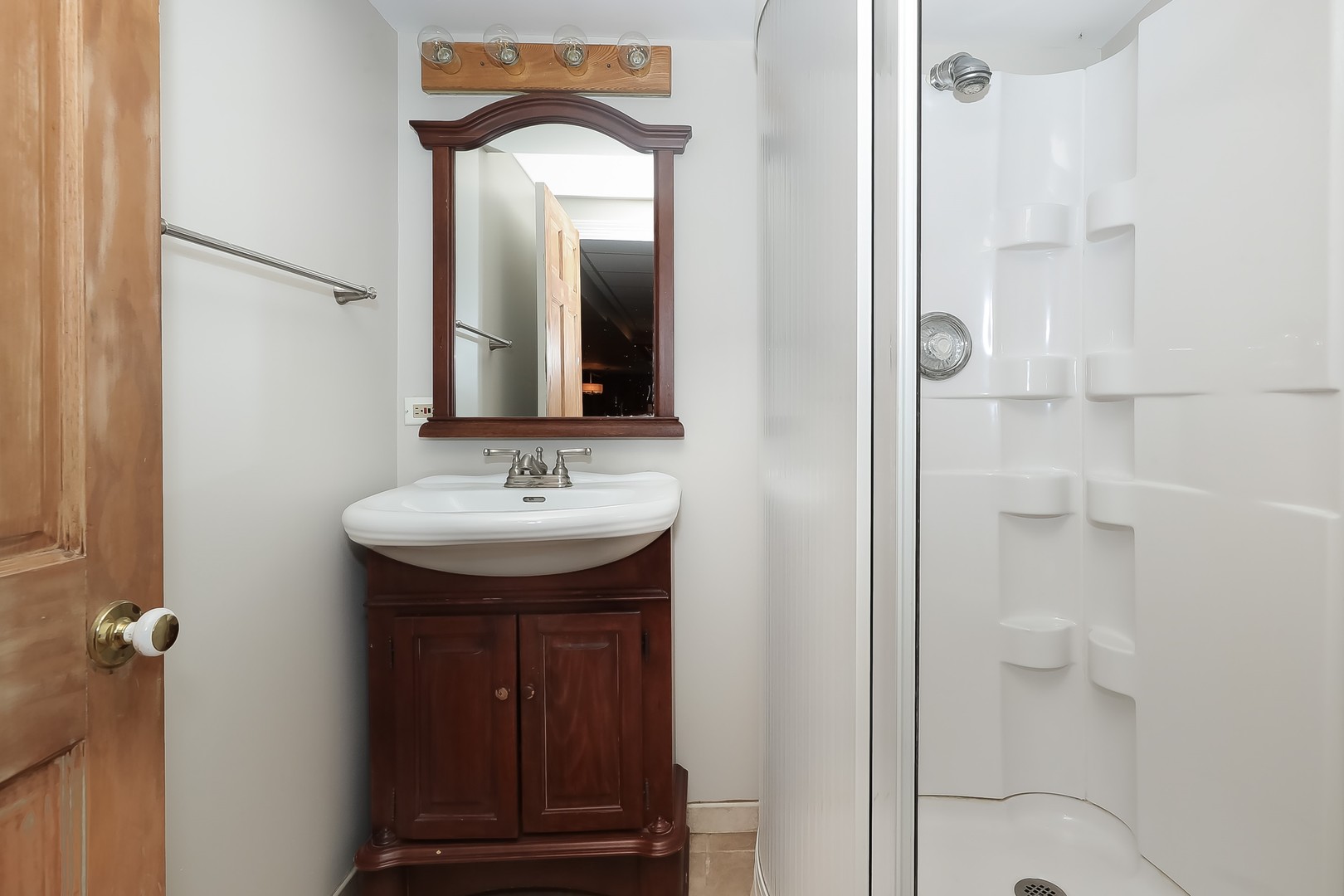 7704 Newbold Road Cary, IL 60013 - Photo 38 of 56 a bathroom with a sink and a mirror