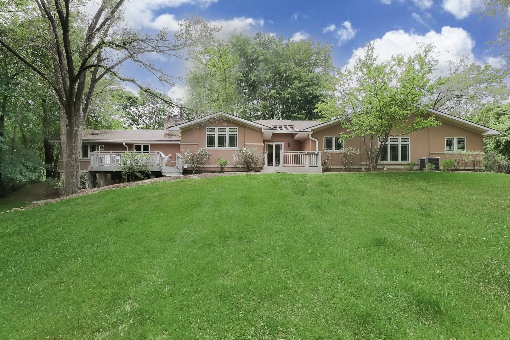 7704 Newbold Road Cary, IL 60013 - Photo 44 of 56 a front view of a house with a garden and trees