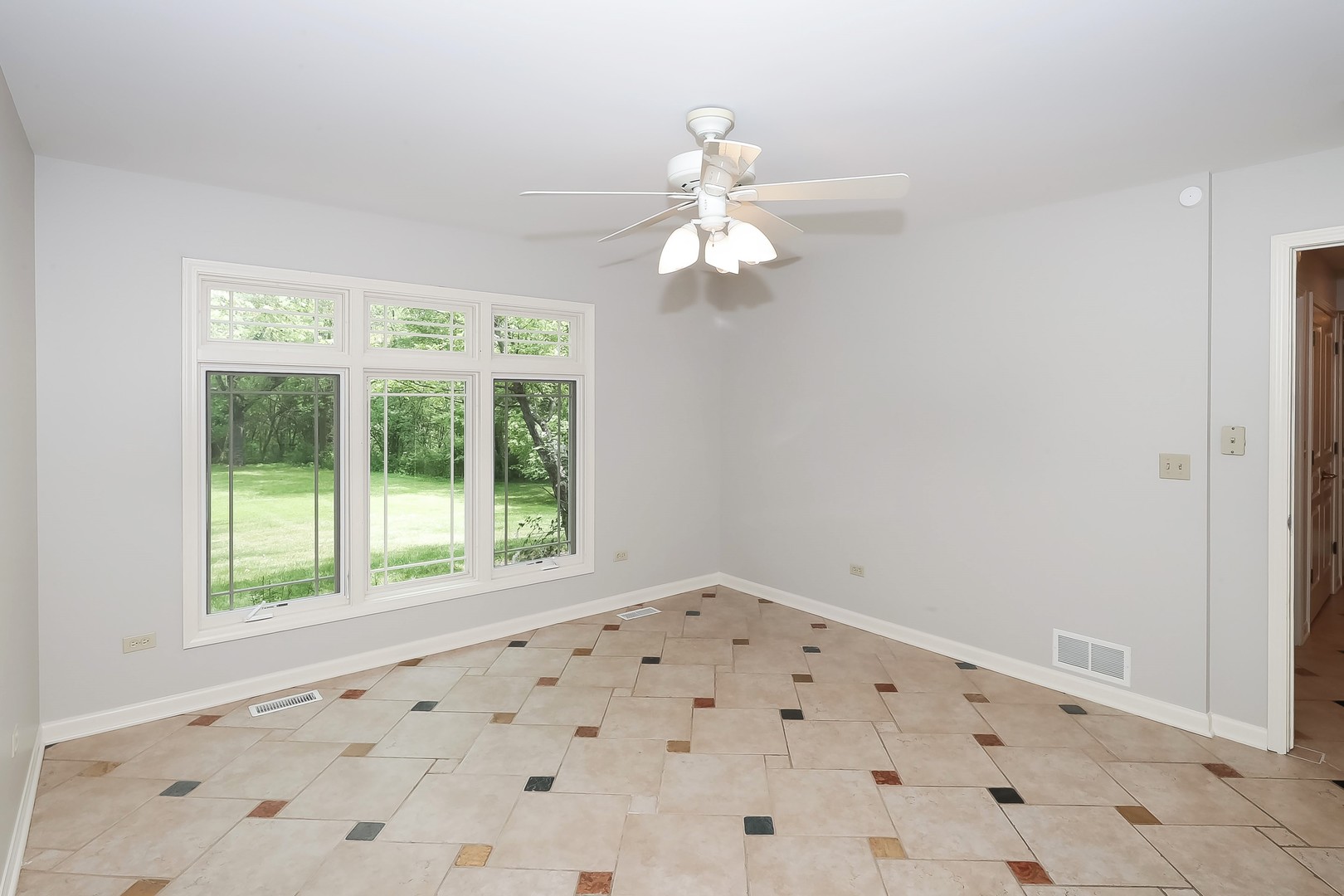 7704 Newbold Road Cary, IL 60013 - Photo 8 of 56 a view of a big room with windows and chandelier fan