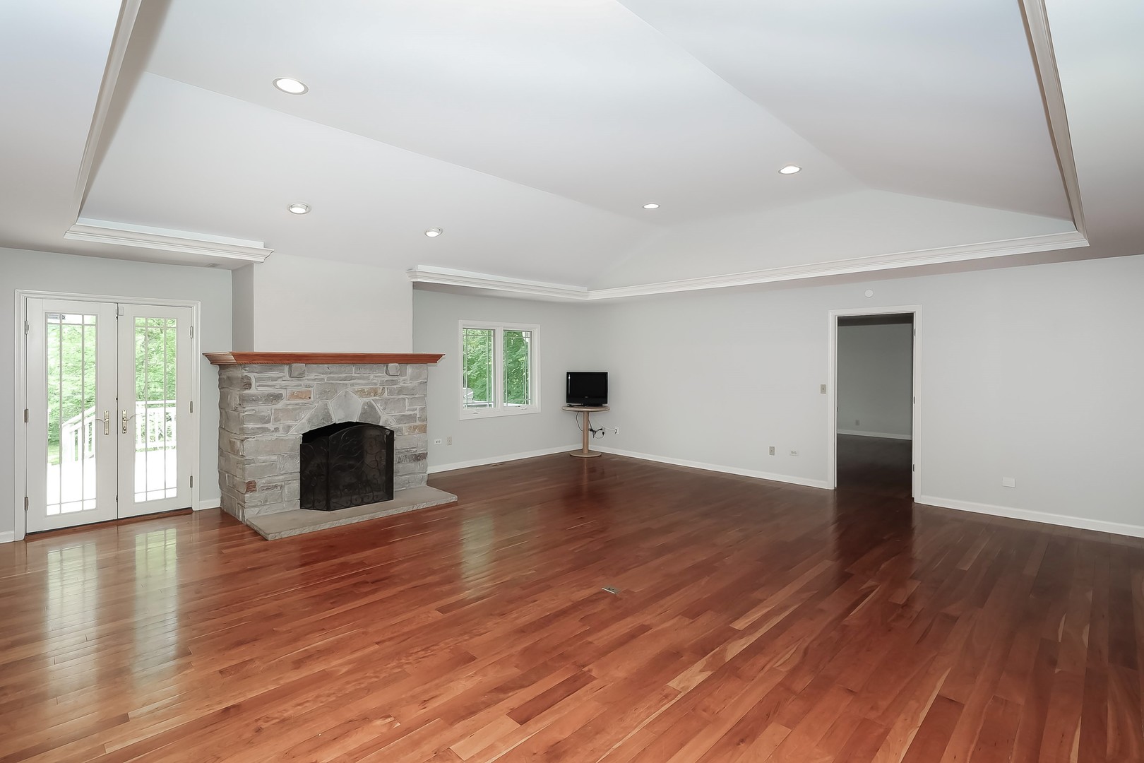 7704 Newbold Road Cary, IL 60013 - Photo 10 of 56 a view of empty room with wooden floor and fireplace