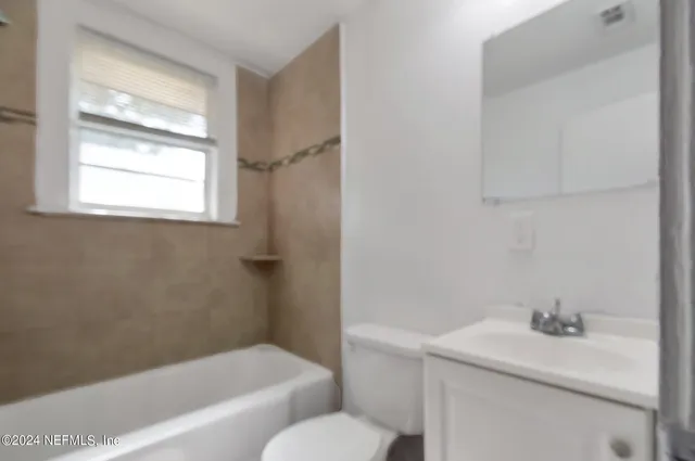 a bathroom with a sink toilet and tub