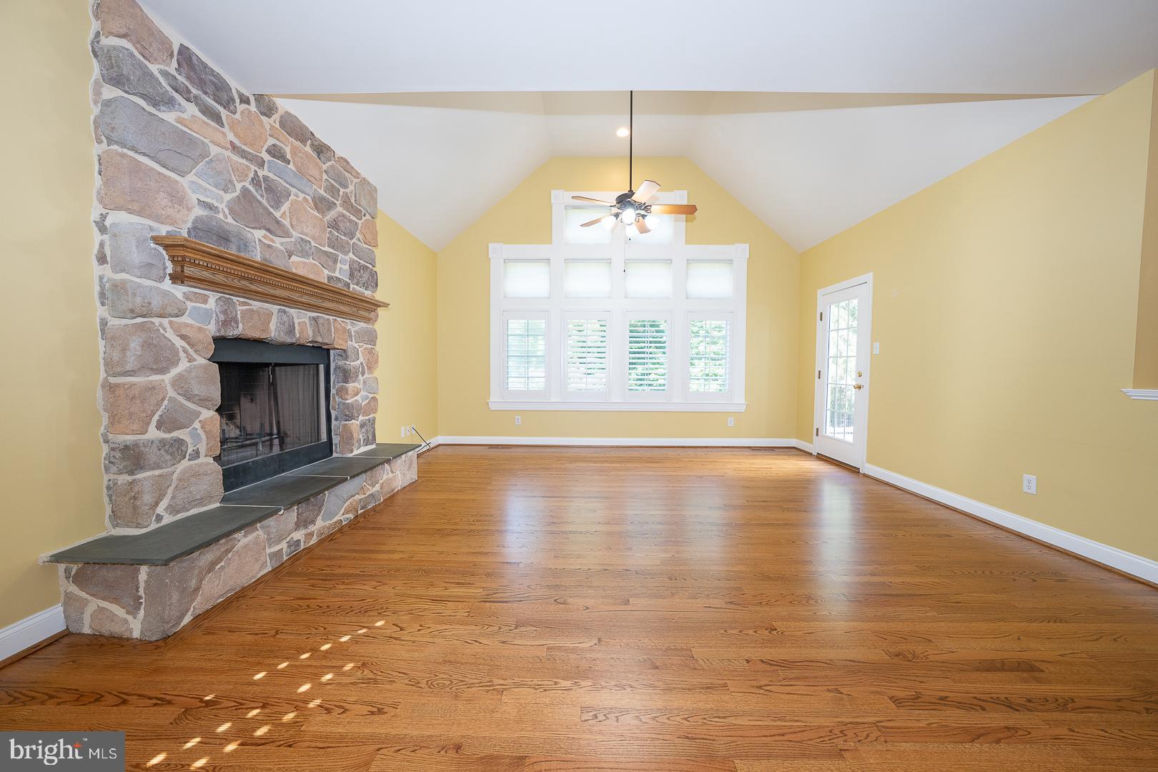 2140 Howell Road Malvern, PA 19355 - Photo 11 of 47 a view of an empty room with wooden floor fireplace and a window