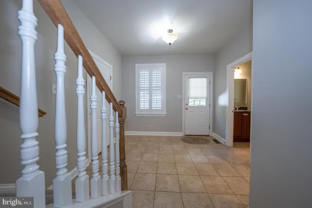 a view of an entryway with wooden floor and windows