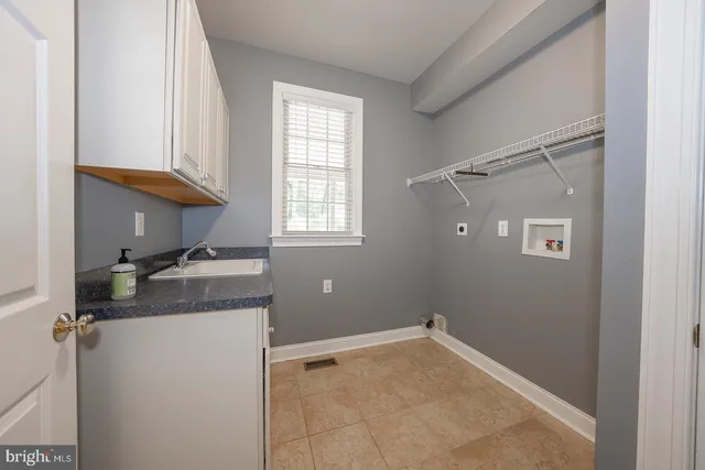 a view of a hallway with wooden floor and stairs