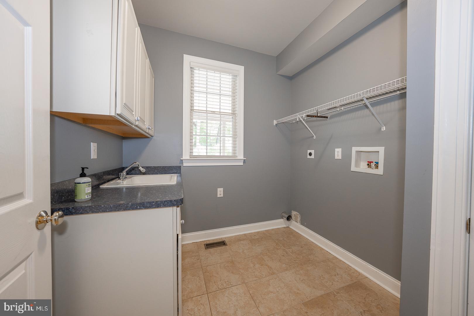 2140 Howell Road Malvern, PA 19355 - Photo 26 of 47 a bathroom with a granite countertop sink and a washing machine