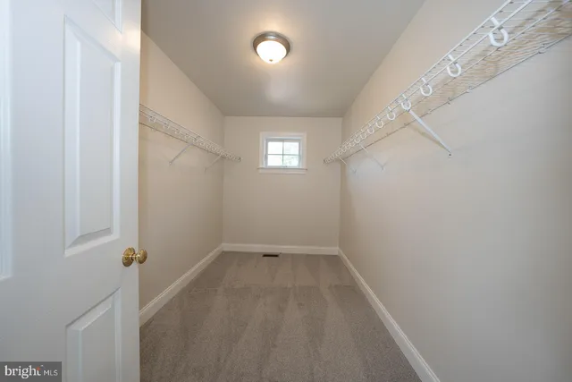 a bathroom with a granite countertop double vanity sink and a mirror
