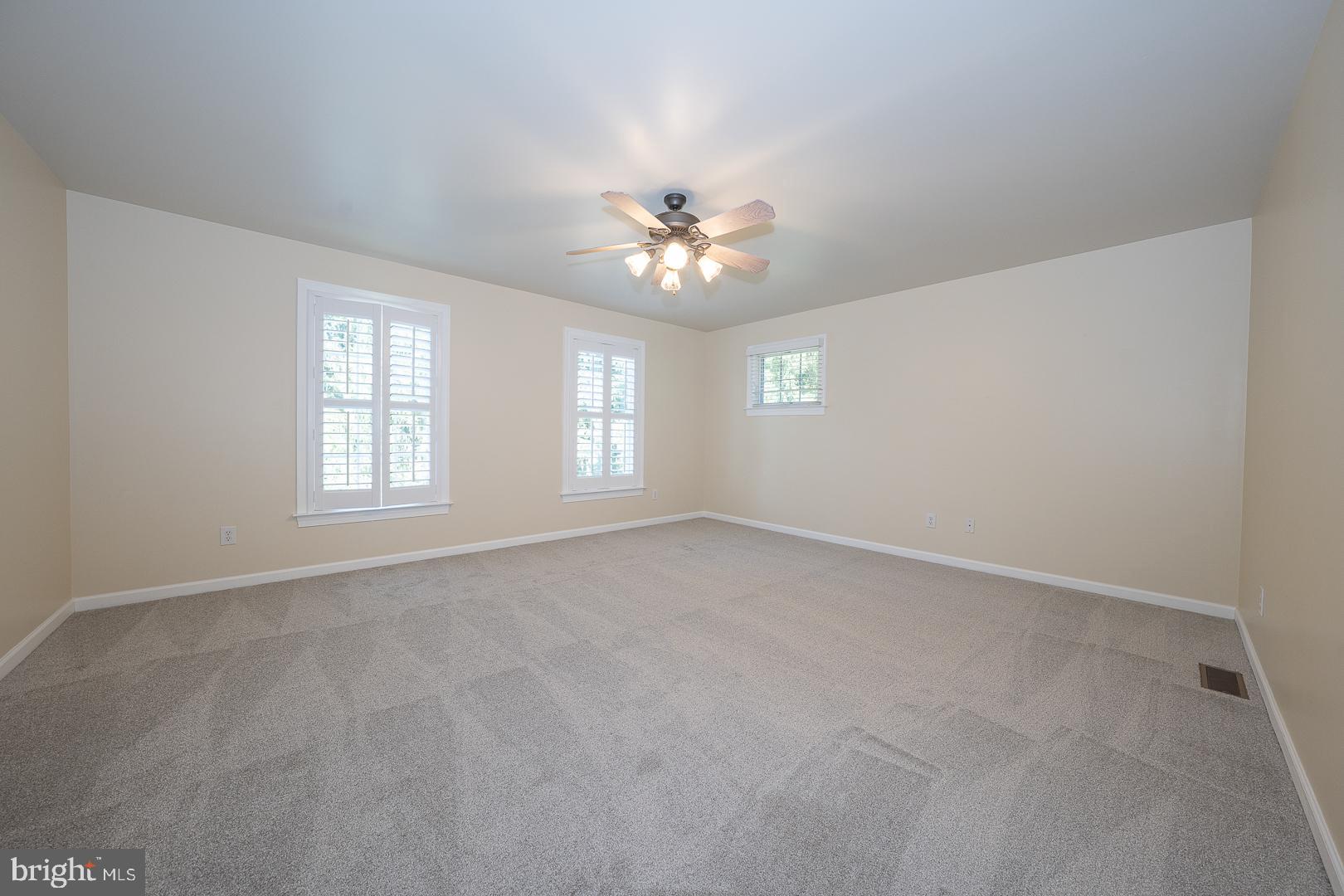 2140 Howell Road Malvern, PA 19355 - Photo 42 of 47 an empty room with windows and chandelier fan