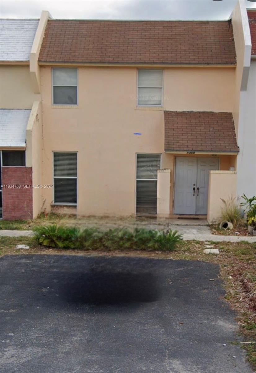 1355 Seaview Pompano Beach, FL 33068 - Photo 1 of 1 a front view of a house with a yard and garage