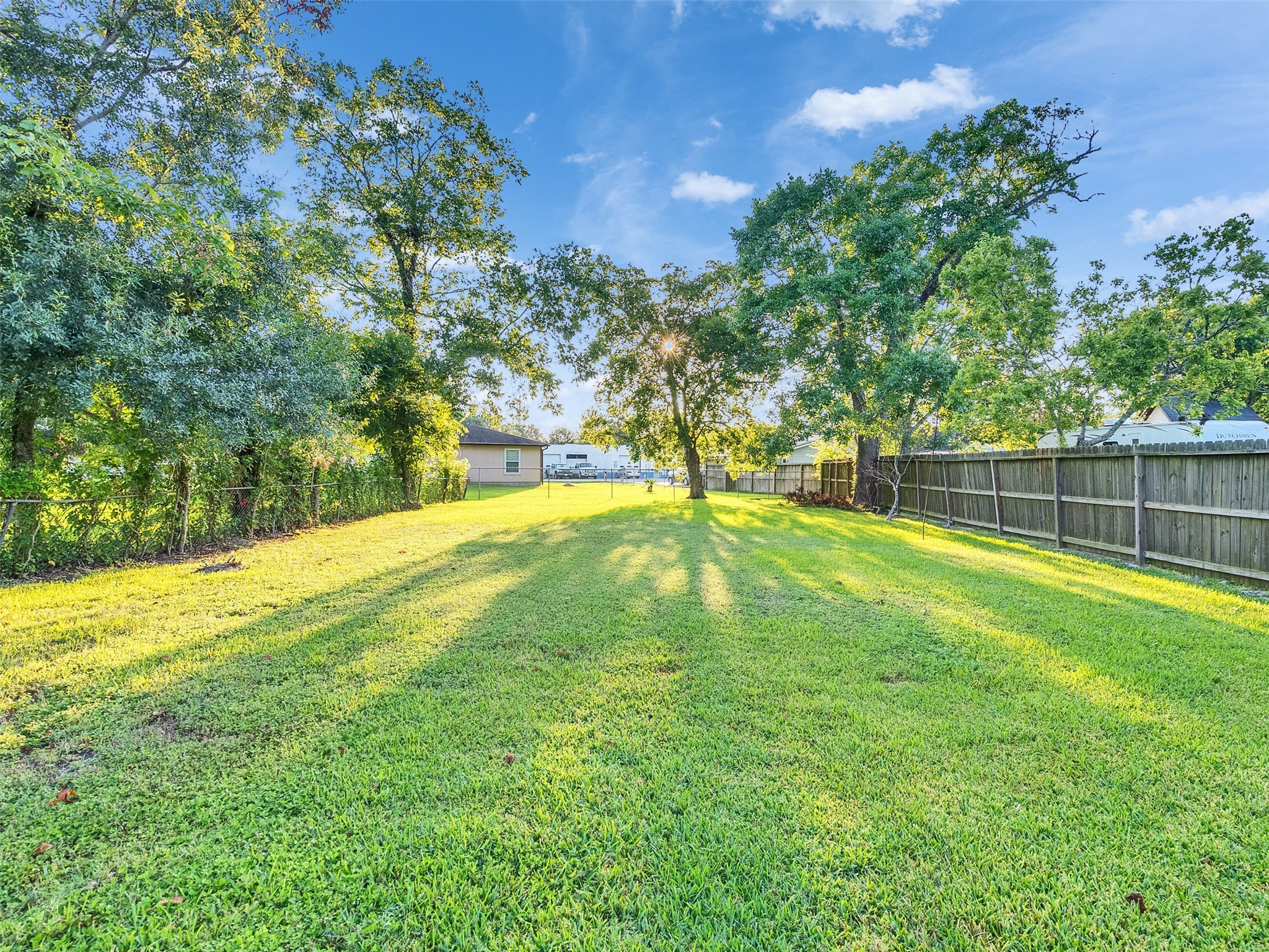 Tbd St Goar Street Dickinson, TX 77539 - Photo 9 of 11 a view of a backyard with large trees and plants