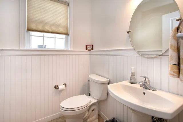 a bathroom with a sink a mirror and a toilet