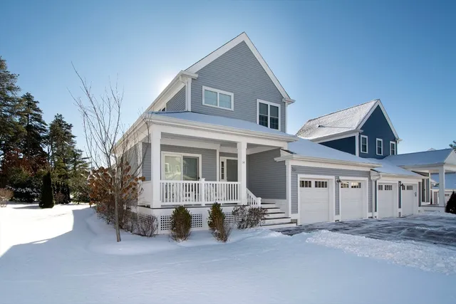 a front view of a house with yard and trees