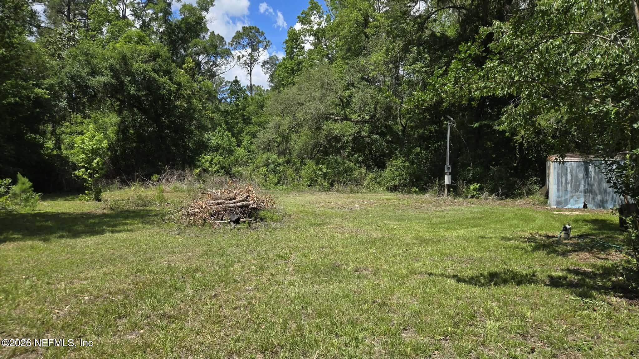 3923 Skipper Road Middleburg, FL 32068 - Photo 11 of 25 a backyard of a house with a yard and outdoor seating